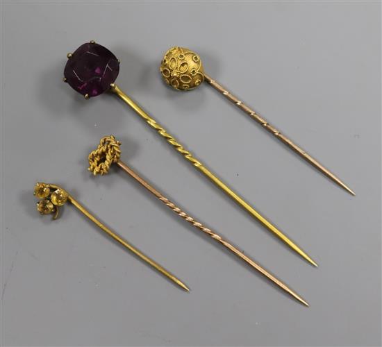 An early 20th century 15ct gold stick pin and three other assorted stick pins.